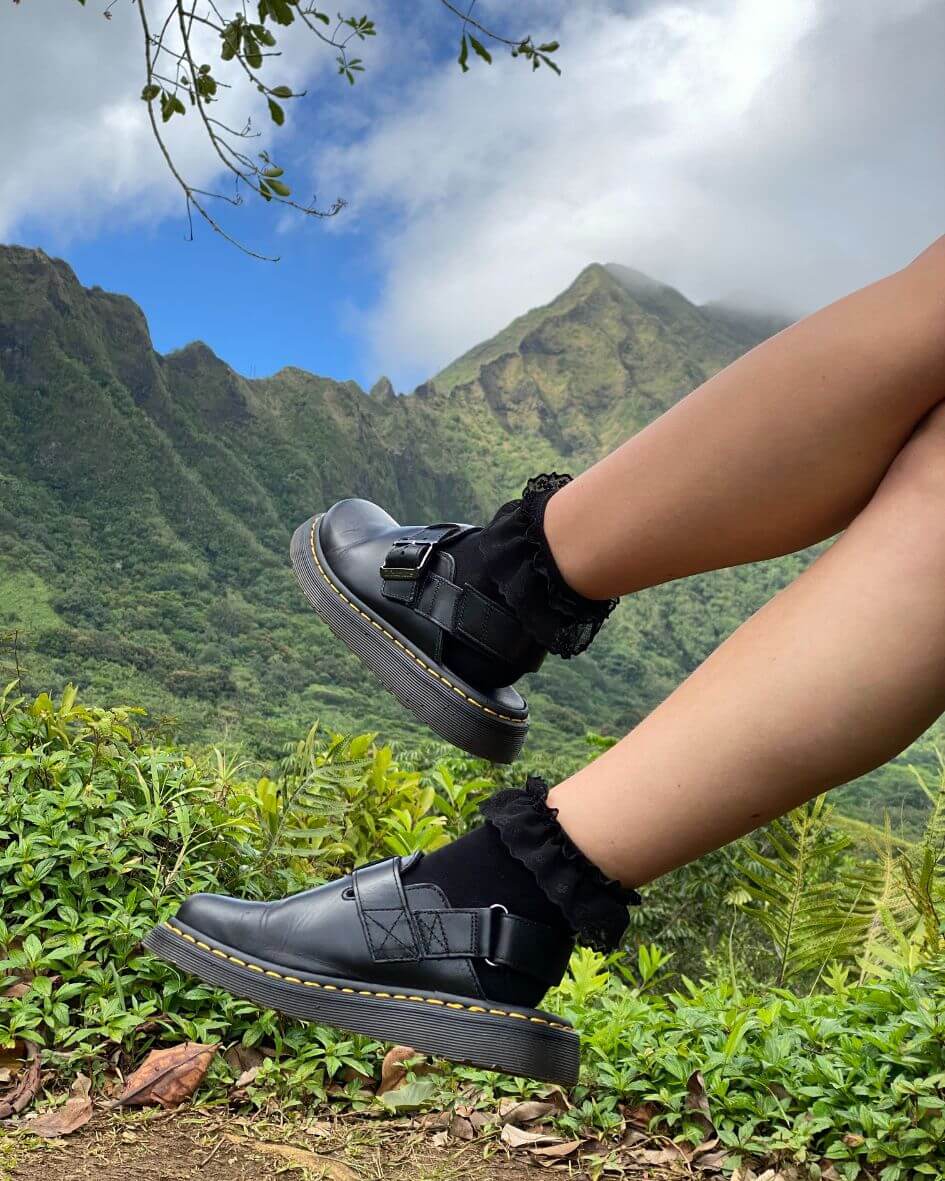 Close-up of black padded lace socks worn with black shoes