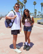 Two people outdoors wearing white Shezza unpadded crew socks with sandals