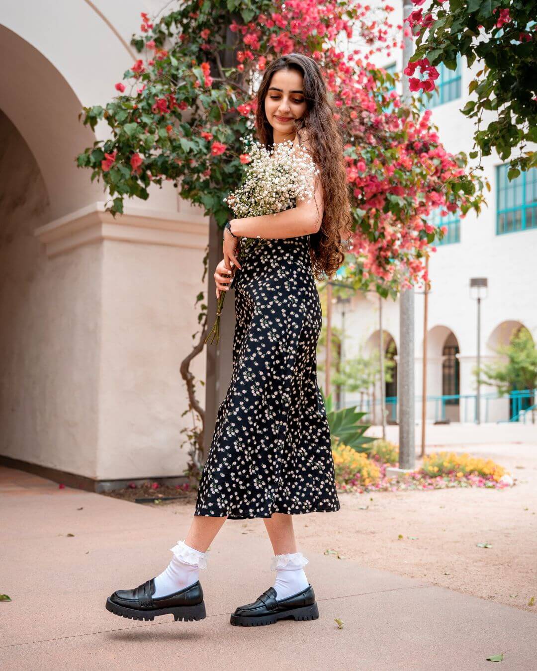 Woman wearing white padded lace socks with black loafers