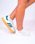White padded ankle sock worn with a green and white Adidas Samba sneaker