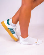 White padded ankle sock worn with a green and white Adidas Samba sneaker