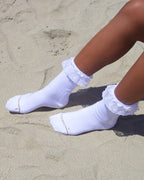White padded lace socks worn on sand
